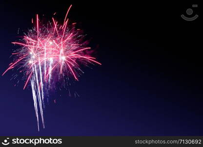 Fireworks abstract on dark background.Colorful firework on the night sky. New Year celebration fireworks. Abstract firework on black background with free space for text