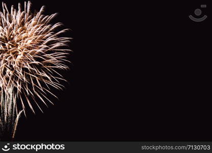 Fireworks abstract on dark background. Colorful firework on the night sky. New Year celebration fireworks. Abstract firework on black background with free space for text