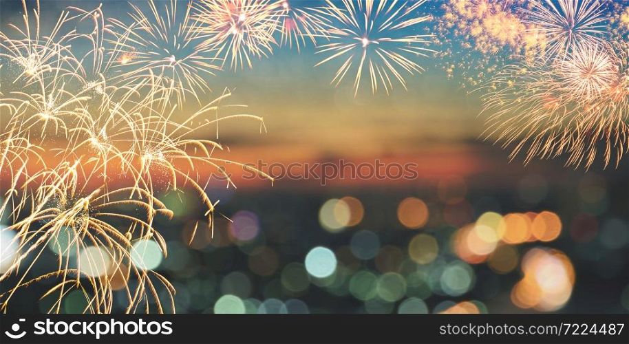 Fireworks and city bokeh lights on twilight sky background with copy space for text. Abstract holiday background