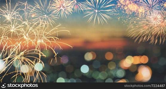 Fireworks and city bokeh lights on twilight sky background with copy space for text. Abstract holiday background