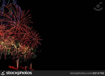 Fireworks banner. Copy space. New Year and Celebration banner. Sparks salute isolated on black background. Festive banner with flashes of fireworks