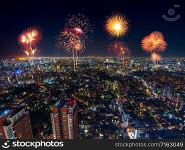 Fireworks celebrating over Tokyo cityscape at night, Japan