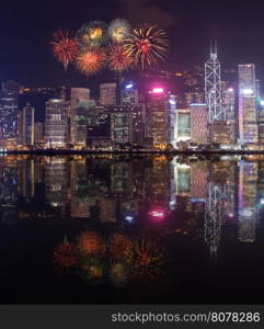 Fireworks Festival over Hong Kong city with water reflection, view from Victoria Harbour