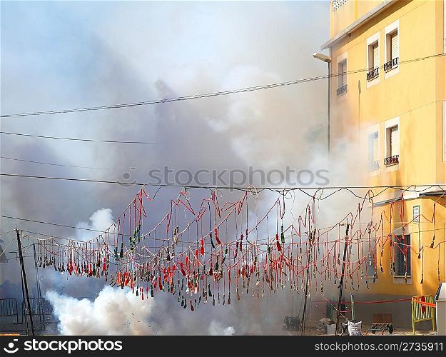 fireworks firecrackers exploding in smoke street in Spain fest