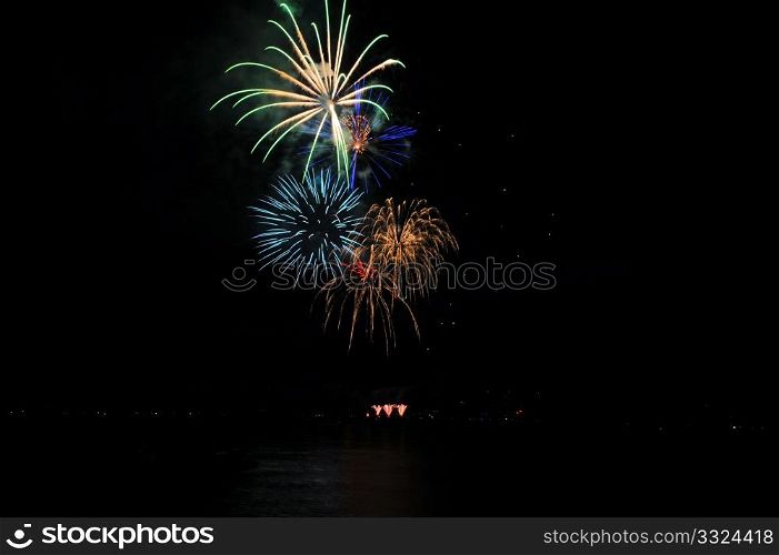 Fireworks In A Rainbow Of Colors. Colorful nighttime fireworks against a solid black sky over Lake Tahoe on the fourth of July holiday 2010