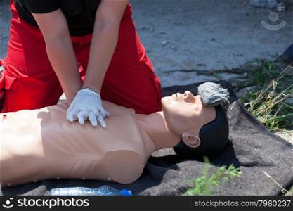 First aid training. CPR being performed on a medical-training manikin.