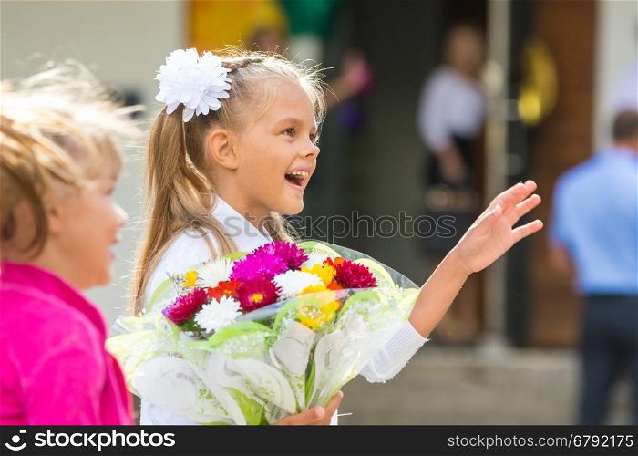 First-grader at the school the first of September in greeting waving his girlfriend