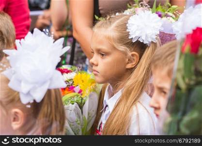First grader standing in a crowd of children on line the first of September