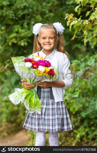 First grader with a bouquet of flowers smiling happily