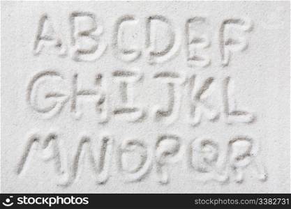 First half of an upper case alphabet written in sand - a designers tool