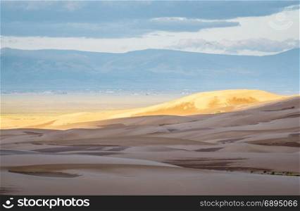 First morning light over Great Sand Dunes National Park and San Louis Valley in Colorado