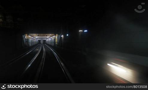 First person window perspective view of underground Paris subway tunnel with station and moving light. View from window in Paris subway