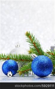 Firtree and christmas decor on glitter silver background