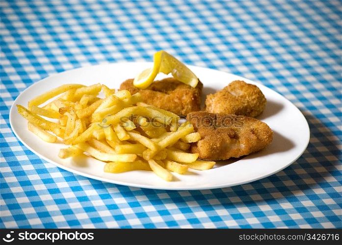 fish and chips in a plate over blue and white table
