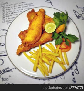 fish and chips meal breaded cod fish fillet with French fries served on plate good british meal usually served in a pub