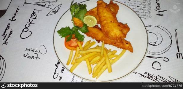 fish and chips meal breaded cod fish fillet with French fries served on plate good british meal usually served in a pub