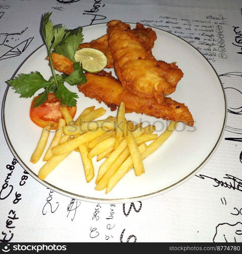 fish and chips meal breaded cod fish fillet with French fries served on plate good british meal usually served in a pub