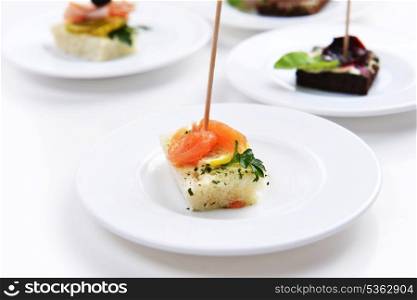 fish and meat sandwiches on wooden chopsticks