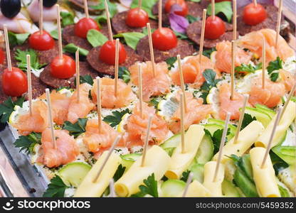 fish and meat sandwiches on wooden chopsticks