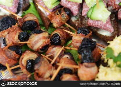 fish and meat snack with vegetables on chopsticks