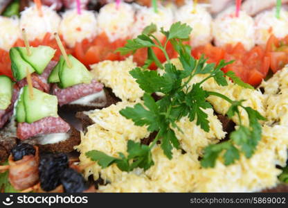 fish and meat snack with vegetables on chopsticks