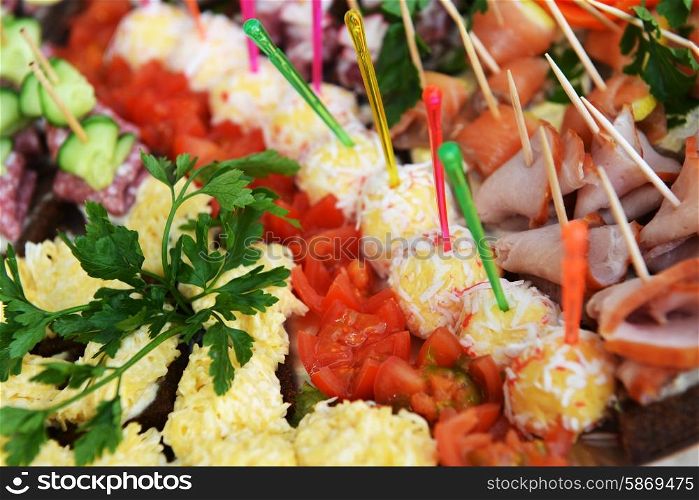 fish and meat snack with vegetables on chopsticks