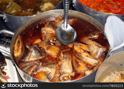 Fish and soup on the stall of street market in Cambodia