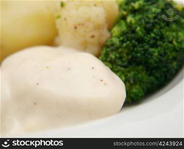 Fish balls in white sauce, with potatoes, broccoli and cauliflower