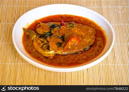 fish curry on bamboo background