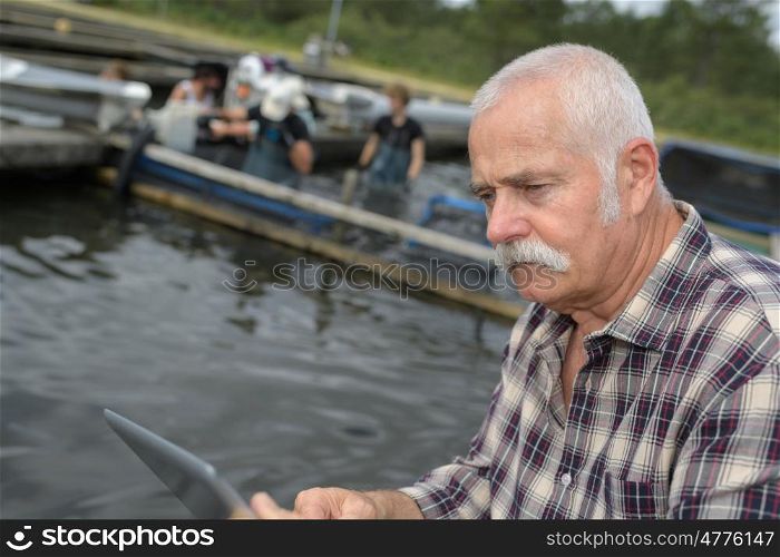 fish farm owner managing his team
