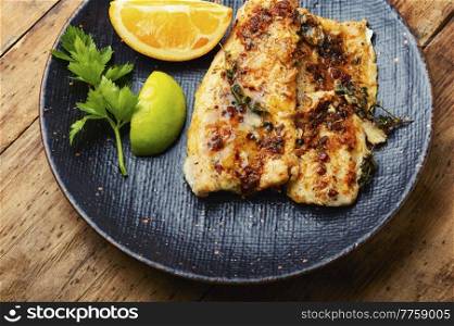 Fish fillet grilled with orange, delicious seafood.. Fried fish fillets in orange oil.