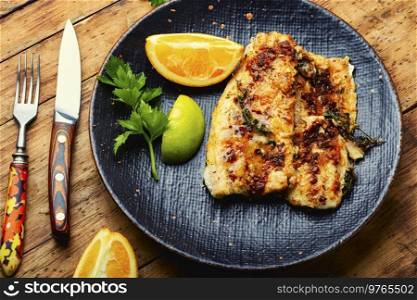 Fish fillet grilled with orange, delicious seafood.. Fried fish fillets in orange oil.
