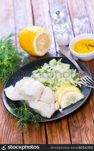 fish fillet with lemon on the plate