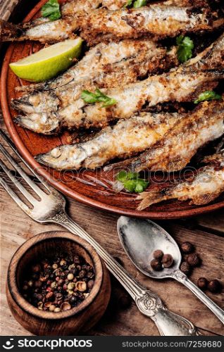 Fish fried breaded on a wooden rustic table. Deep fried fish