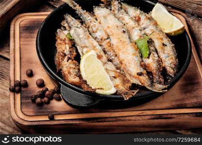 Fish fried breaded on iron cast pan.Deep-fried fish. Deep fried fish