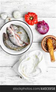Fish in bowl. Process of cooking fish perch and frying in flour