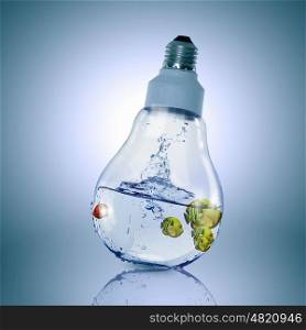 Fish in light bulb. Exotic fish in water inside electric light bulb