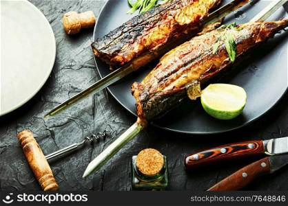 Fish kebab from mackerel. Mackerel on skewers. Grilled fish.. Whole grilled mackerel,skewered