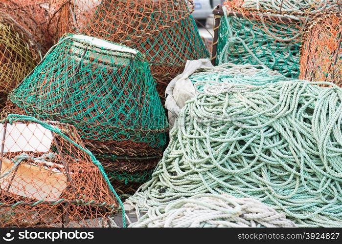 Fish nets background. Background of fish nets and fishing equipment in green and orange colors