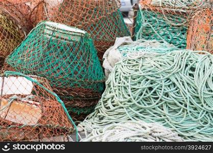 Fish nets background. Background of fish nets and fishing equipment in green and orange colors