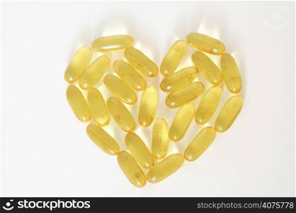 Fish oil capsules forming a shape of heart