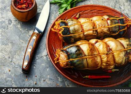 Fish roll up made from smoked mackerel.Hot smoked fish.. Plate with smoked fish