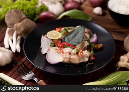 Fish salad with lime, chili, lemongrass, onions, red onions, parsley and kaffir lime leaves in the plate.
