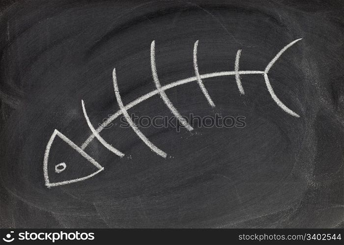 fish skeleton - white chalk drawing on blackboard with eraser smudges and texture