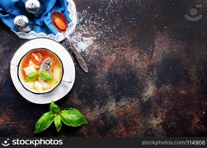 fish soup in bowl and on a table