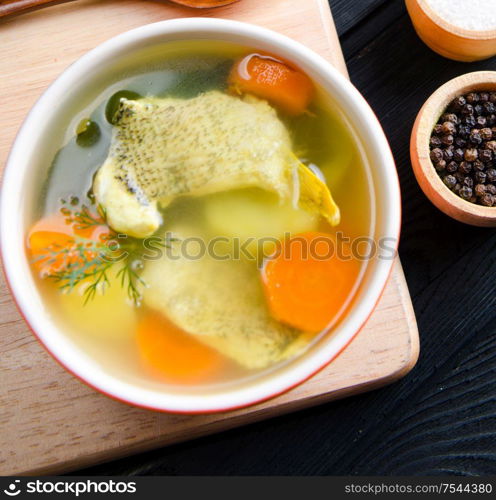 Fish soup served on the table in plate. The fish soup served on the table in plate