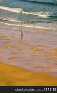 Fisherman angler with fishing rod on sea shore.. Angler with fishing rod on sea shore