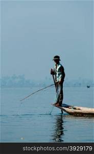 Fisherman at Inle Lake working on one foot. Fisherman at Inle Lake working on one foot Burma Myanmar