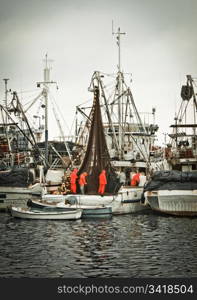 Fisherman crew fixing nets on fishing boat, Zadar, Croatia