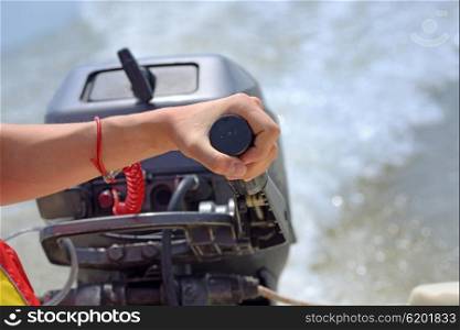 fisherman hand and speed boat engine